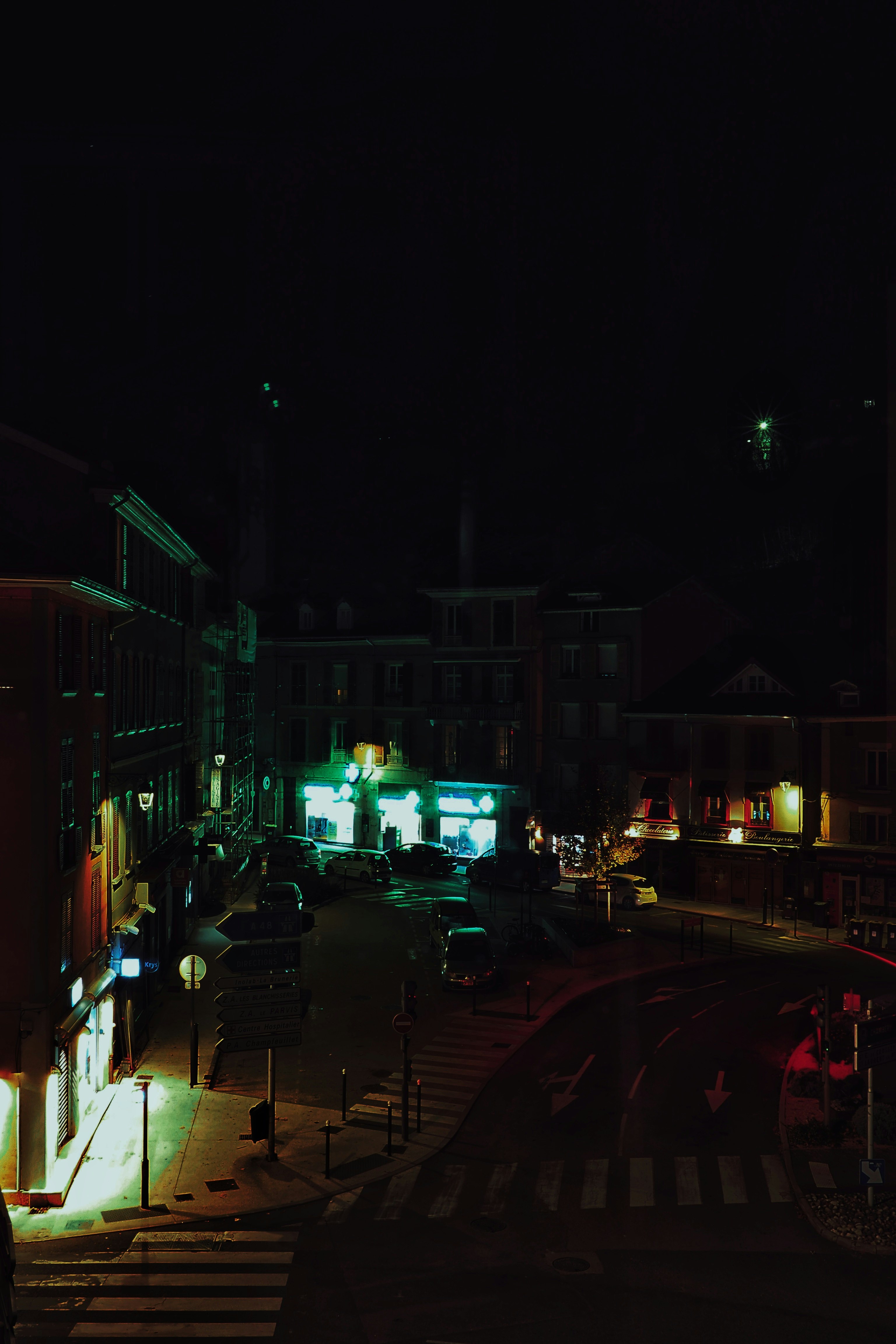 cars parked on side of the road during night time